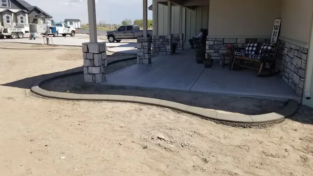 A smooth edge follows a rounded planting strip at the base of a covered patio.