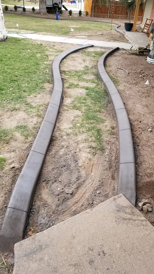 A portrait looks between two curving concrete borders toward an existing walkway.